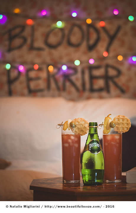 Drinks on a table in front of a Bloody Perrier backdrop