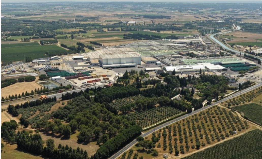 Aerial view of a large industrial production facility surrounded by farmland